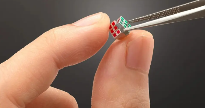 Tiny Rubik's cube with tweezers.